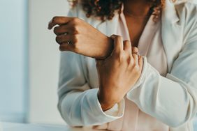 woman holding wrist 