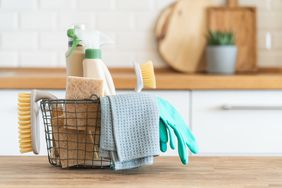 Basket with brushes, rags, natural sponges and cleaning products