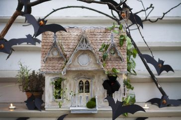 miniature haunted house on porch