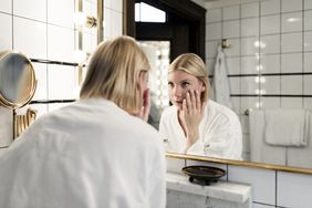 woman looking in mirror