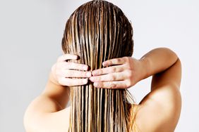 woman rinsing hair getty