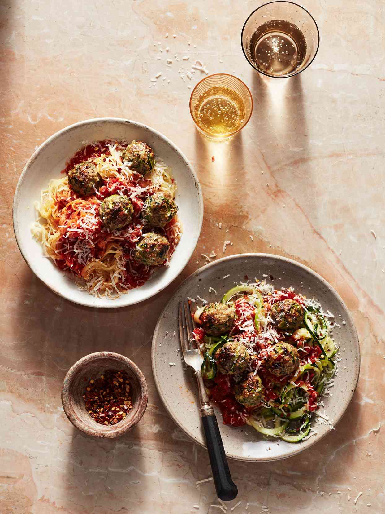 bowls of spaghetti squash and zucchini noodles with zucchini meatballs