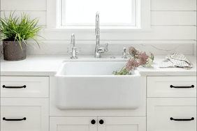 White sink with pink flowers in it 